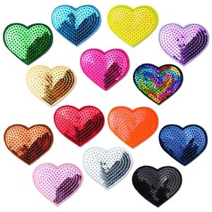 Flat lay of colorful heart-shaped sequin patches in red blue gold and silver