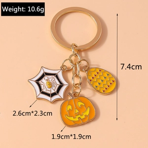 Detail of Halloween keychain with spider web and pumpkin charms showing dimensions and weight