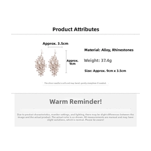 Detailed view of layered snowflake tassel earrings with pavé rhinestones in rose gold finish