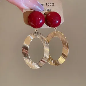 Vintage red resin bead earrings with large brushed oval gold-tone metal pendants
