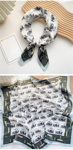 Detail of silk square scarf featuring vintage horse carriage pattern and green borders