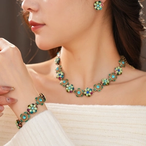 Close-up of vintage flower jewelry set with rhinestones worn by a model
