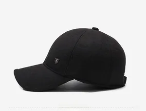 Close-up of black winter baseball cap featuring a metal shield logo and durable stitching