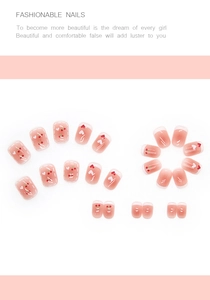 Detail of sweet pink jelly press-on nails with cute cherry and heart gradient design