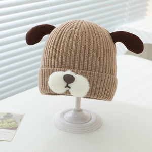 Close-up of baby winter knit hat with cute puppy ears and warm ribbed texture