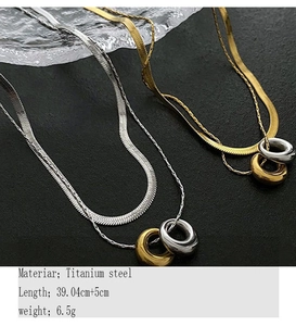 Detail of titanium steel double-layer snake chain with dual interlocking ring pendants