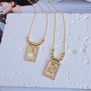 Detailed macro view of 18K gold plated Baroque pendant necklaces with pearls on white stone