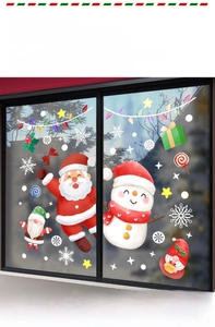 Detail of Christmas window clings featuring Santa, snowmen and vibrant watercolor snowflakes