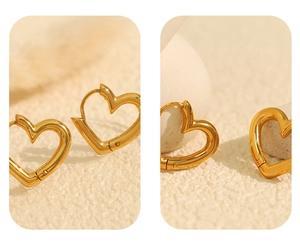Detailed close-up of vintage golden heart earrings with smooth geometric polished lines