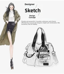 Macro detail of large silver metallic tote bag with multiple zip pockets and sturdy handles