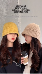 Detail of chunky knit fisherman hat texture in ginger yellow and beige coffee tones