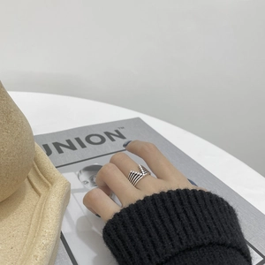 Close-up of S925 sterling silver V-shaped layered ring worn on hand with vintage texture