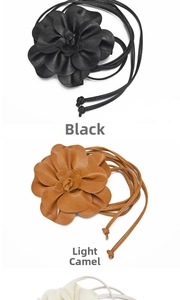 Detailed view of handmade PU leather flower belts in black and light camel shades