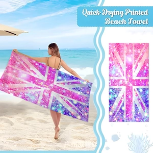 Quick-drying microfiber beach towel with a purple Union Jack pattern shown in a coastal setting