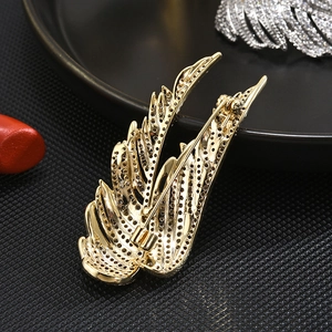Back view of gold-plated wing brooch with pavé texture and secure pin closure