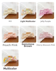 Macro display of seven colorful hollow acetate hair claws in various marble patterns