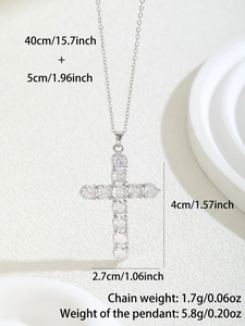 Close-up of a silver cross pendant inlaid with brilliant cubic zirconia on a necklace