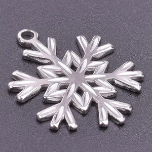 Macro shot of silver snowflake pendant accessory with polished stainless steel finish