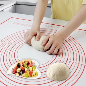 Close-up of silicone baking mat featuring red circular scales and temperature icons