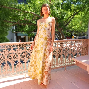 Close-up of floral print maxi dress with spaghetti straps and flowing hem design