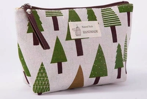 Close-up of canvas makeup bag with pine tree pattern and Natural Style handmade label