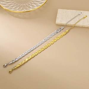 Detailed shot of two-tone braided snake chain bracelets in gold and silver steel finish