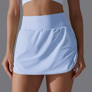 Detail view of high-waisted tennis skirt with side pocket and curved hem in light blue