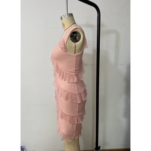 Side view of a pink sleeveless dress featuring multi-layered ruffle design on a mannequin