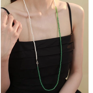 Close-up of pearl and green agate beaded necklace on model showing the elegant detail