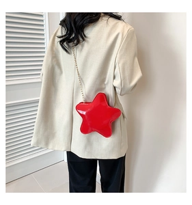 Detail view of red star-shaped PU leather crossbody bag with elegant metal chain strap