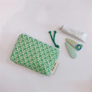 Detailed view of floral cotton storage pouch with zipper and simple wish label