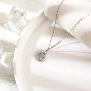 Minimalist 18K gold nautilus shell pendant necklace for women on white display