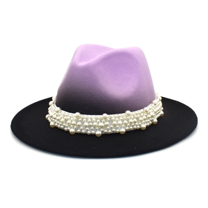 Close-up of wide brim fedora with purple gradient felt and white pearl decorative band