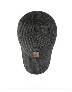 Top view of dark grey knitted baseball cap with a classic stitched brown leather patch