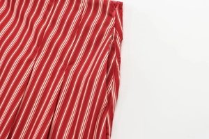 Detail of red and white vertical stripes fabric with concealed side zipper closure