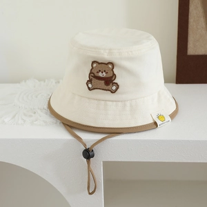 Detail of baby sun hat with cute bear embroidery and adjustable chin strap