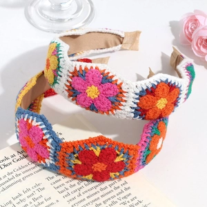 Close-up of handmade crochet headbands with intricate floral patterns on an open book
