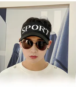 Close-up of black knitted sun visor hat with white SPORT embroidery and aviator sunglasses