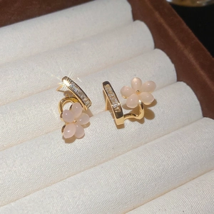 Close-up of 18k gold plated flower stud earrings with pink petals and zircon stones