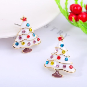 Close-up of white enamel Christmas tree earring with colorful rhinestones and festive decor