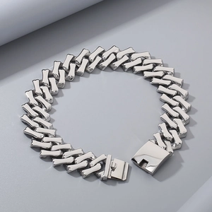 Close-up of polished silver 32mm diamond-cut Cuban chain link bracelet with box clasp