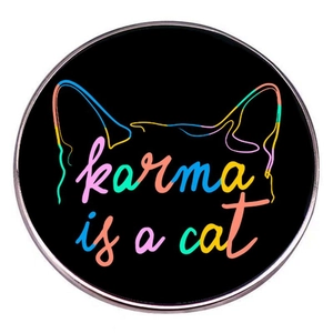 Round Karma is a cat metal brooch pin with black background and feline ear outlines