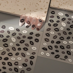 Detailed view of FEB-946 lip print nail stickers with black and white patterns applied