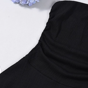 Close-up of black pleated fabric texture with elegant blue flower petals background