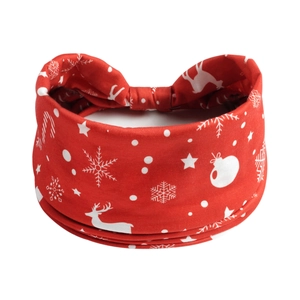 Detail of red Christmas headband featuring white reindeer, snowflake, and star patterns