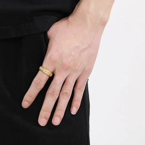 Detail of a men's gold stainless steel ring featuring a vintage hammered texture