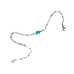 Silver bracelet with rectangular turquoise gemstone and heart charm on white background