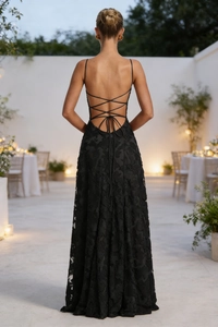 Detail of backless cross lace-up design on a black jacquard long dress for women