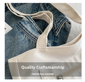 Close-up of white nylon tote bag showing high-quality silver metal zipper pocket details