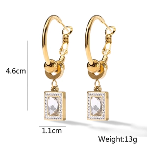 Detail view of gold hoop earrings with zircon pendants including size 4.6cm and weight 13g